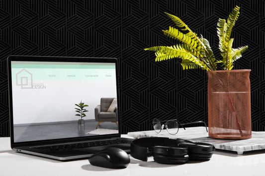 Free Front View Of Desk With Laptop And Plant Psd