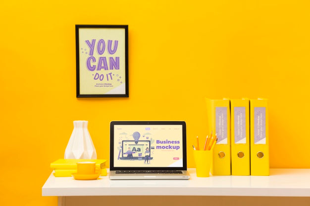 Free Front View Of Desk With With Frame And Laptop Psd