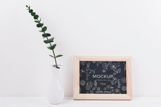 Free Front View Of Frame Mock-Up With Vase And Plant Psd