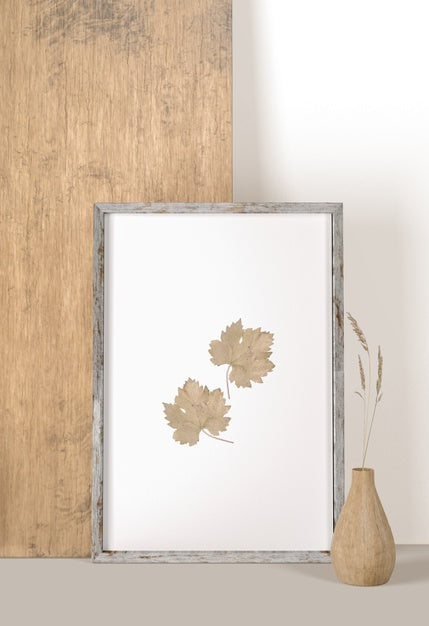 Free Front View Of Frame With Leaves And Vase With Flower Psd