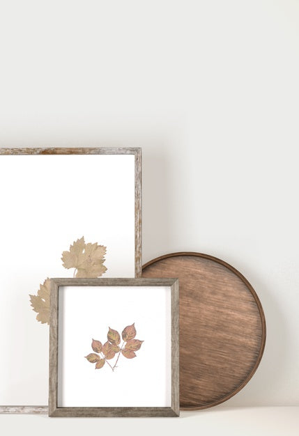 Free Front View Of Frames With Leaves And Wooden Tray Psd