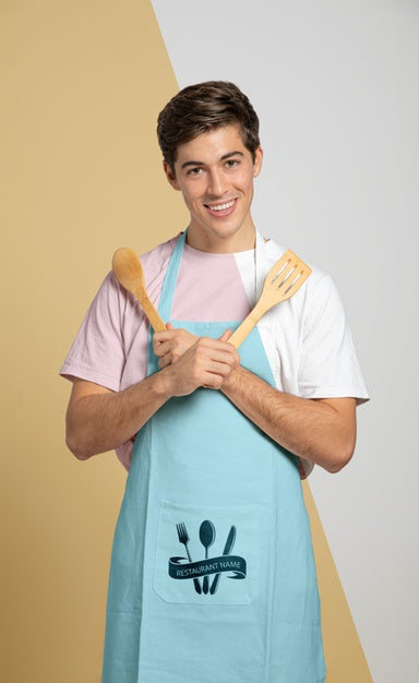Free Front View Of Man In Apron Holding Wooden Spoons Psd