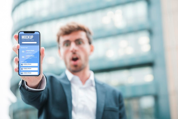 Free Front View Of Shocked Businessman Holding Smartphone Psd