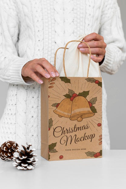 Free Front View Of Woman Holding Christmas Paper Bag With Pine Cone Psd