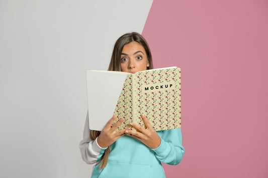 Free Front View Of Woman Holding Up Book Psd