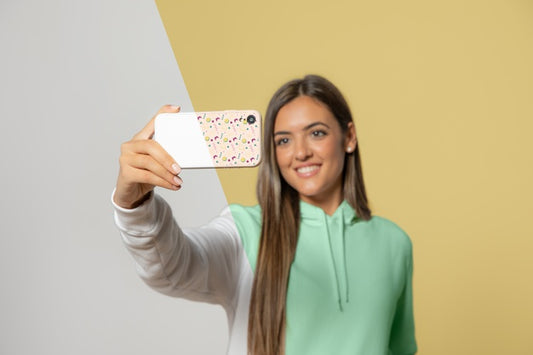 Free Front View Of Woman In Hoodie Taking Selfie With Smartphone Psd