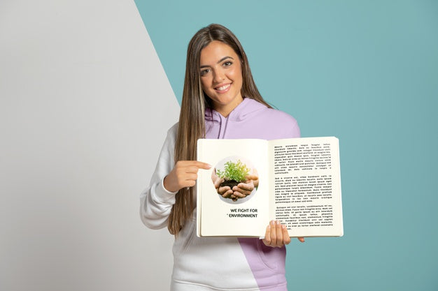 Free Front View Of Woman Pointing At Book She'S Holding Psd