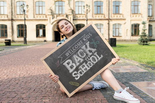 Free Girl Holding Back To School Blackboard Mock-Up Psd