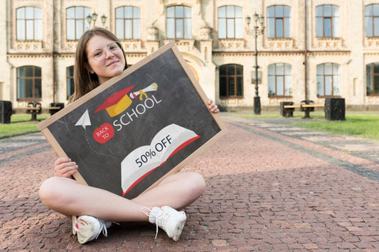 Free Girl Sitting While Holding A Blackboard Mock-Up Psd