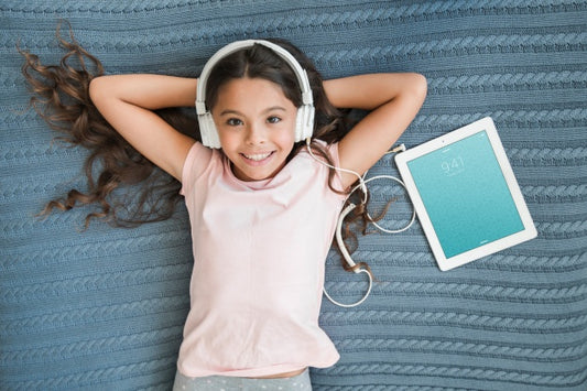 Free Girl With Headphones Next To Tablet Mockup Psd