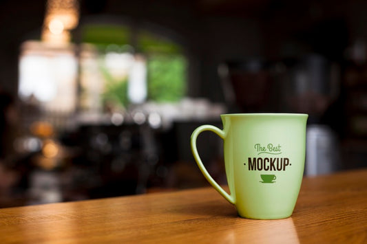 Free Green Coffee Cup On Wooden Table Psd