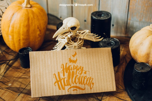 Free Halloween Mockup With Cardboard And Bird Skeleton Psd