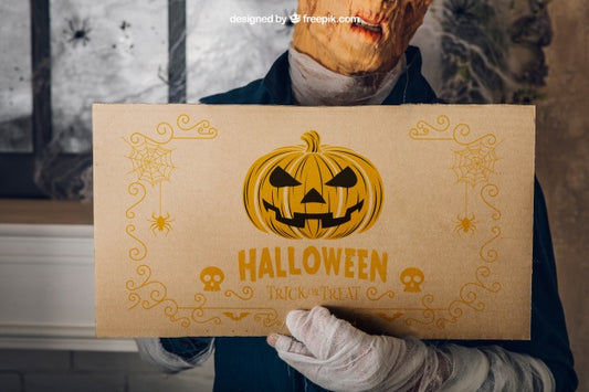 Free Halloween Mockup With Man Holding Cardboard Psd