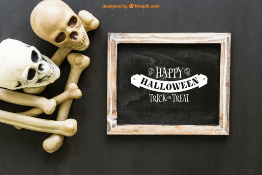 Free Halloween Slate Mockup With Two Skulls And Bones Psd