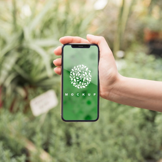 Free Hand Holding Smartphone Mockup With Gardening Concept Psd