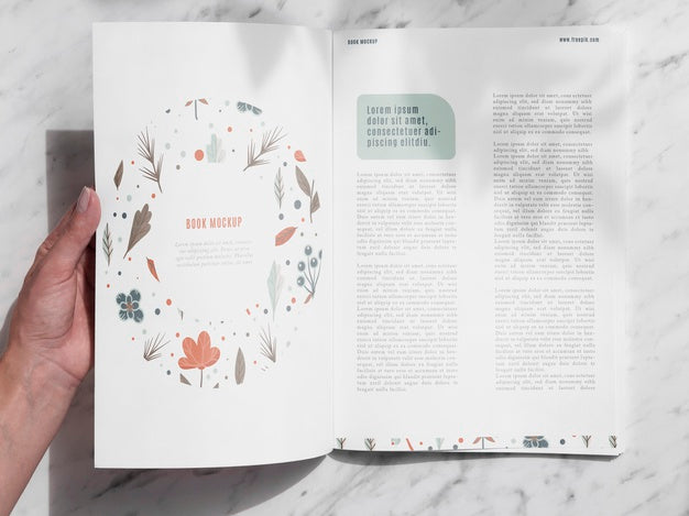 Free Hand Opening A Magazine On Grey Background Psd