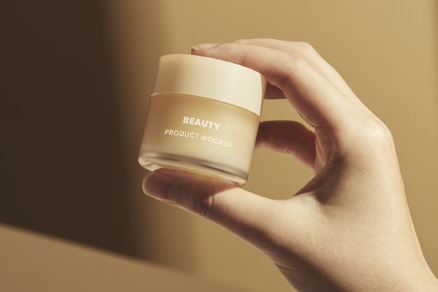 Free Hand With Small Beige Cream Pot Mockup Psd
