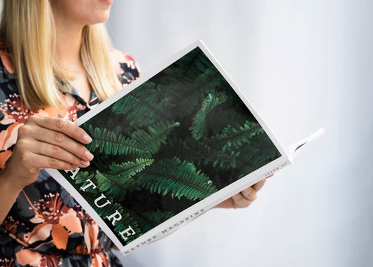 Free Hands Holding A Nature Mock Up Magazine Psd