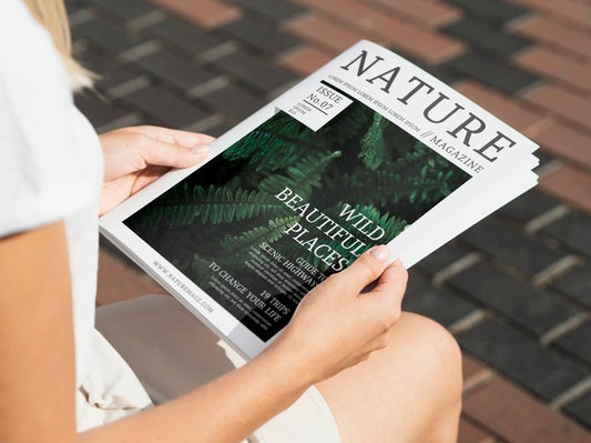 Free Hands Holding A Wild Nature Magazine Mock Up Psd
