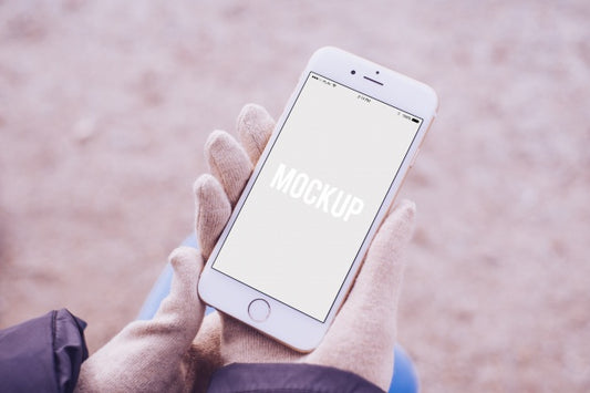 Free Hands With Gloves Holding A Smartphone Mock Up Psd