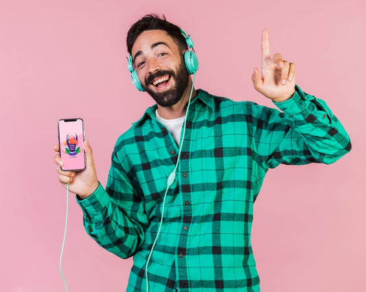 Free Happy Bearded Man With Headphones And Cell Phone Mock Up Psd