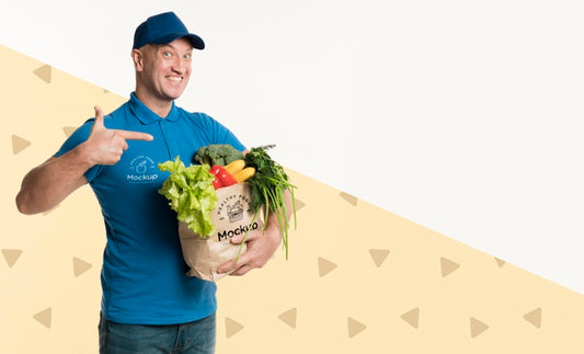 Free Happy Delivery Man Holding A Box With Different Vegetables With Copy Space Psd