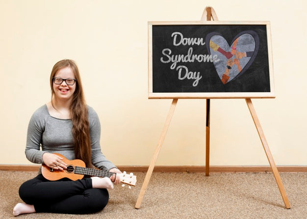 Free Happy Girl With Down Syndrome Playing Ukulele With Blackboard Mock-Up Psd