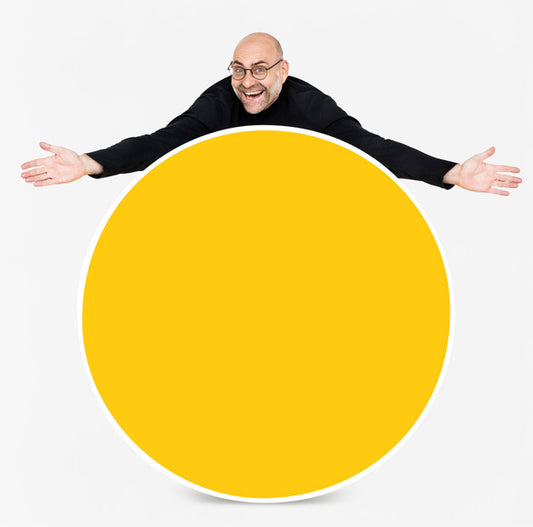 Free Happy Man Showing A Round Yellow Board Psd