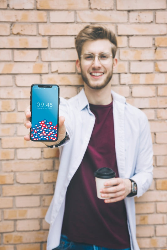 Free Happy Man Showing Smartphone Psd