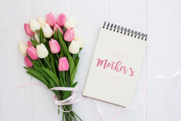 Free Happy Mother'S Day Mock Up On Notebook With Pink And White Tulips, On White Wooden Background Psd