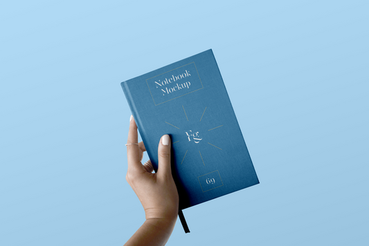 Free Hard Cover Notebook With Hand Mockup