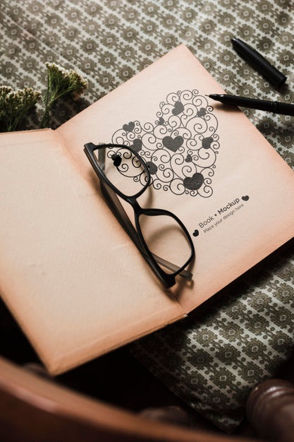 Free High Angle Of Book With Glasses And Pen Psd