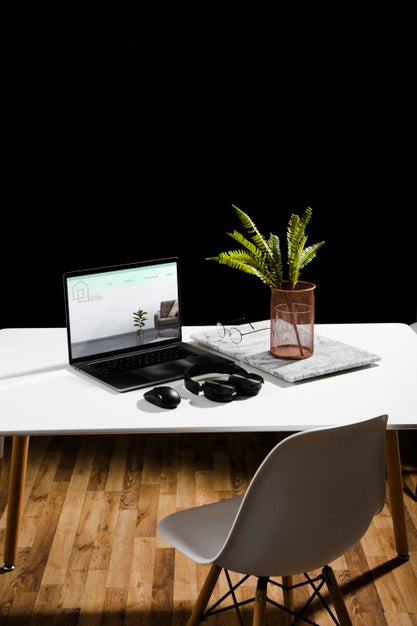 Free High Angle Of Desk With Laptop And Plant Psd