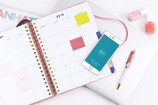 Free iPhone Mockup With A Calendar On A Table