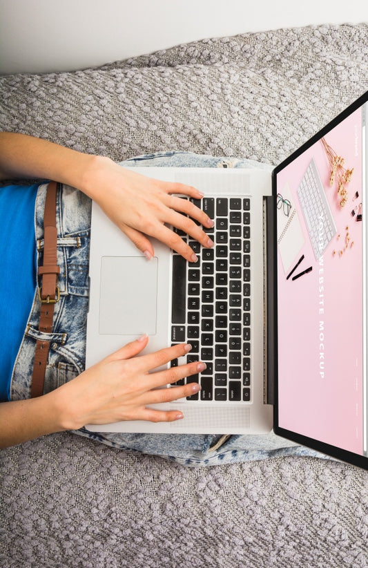 Free Laptop Mockup On Bed With Hands Psd
