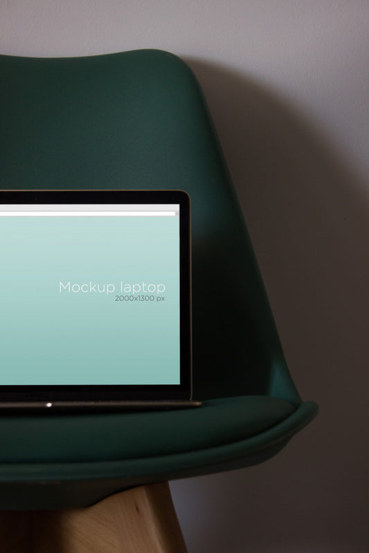 Free Laptop Mockup On Chair Psd