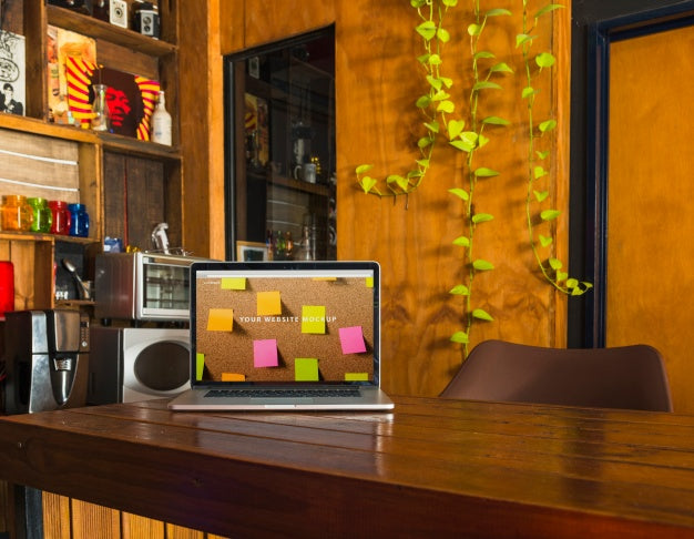 Free Laptop Mockup On Wooden Table Psd