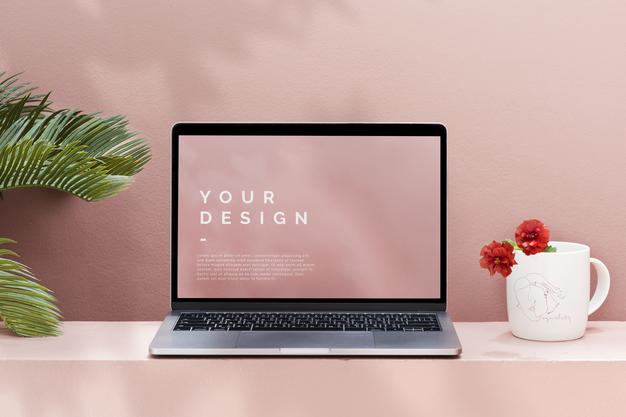 Free Laptop Mockup With A Pastel Pink Wall Psd