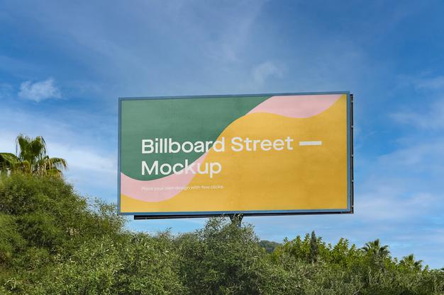 Free Large Billboard Mockup On Blue Sky With Trees Psd