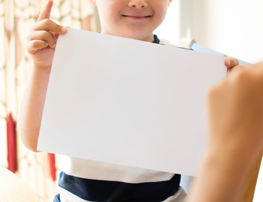 Free Little Boy With A Blank Paper Mockup Psd
