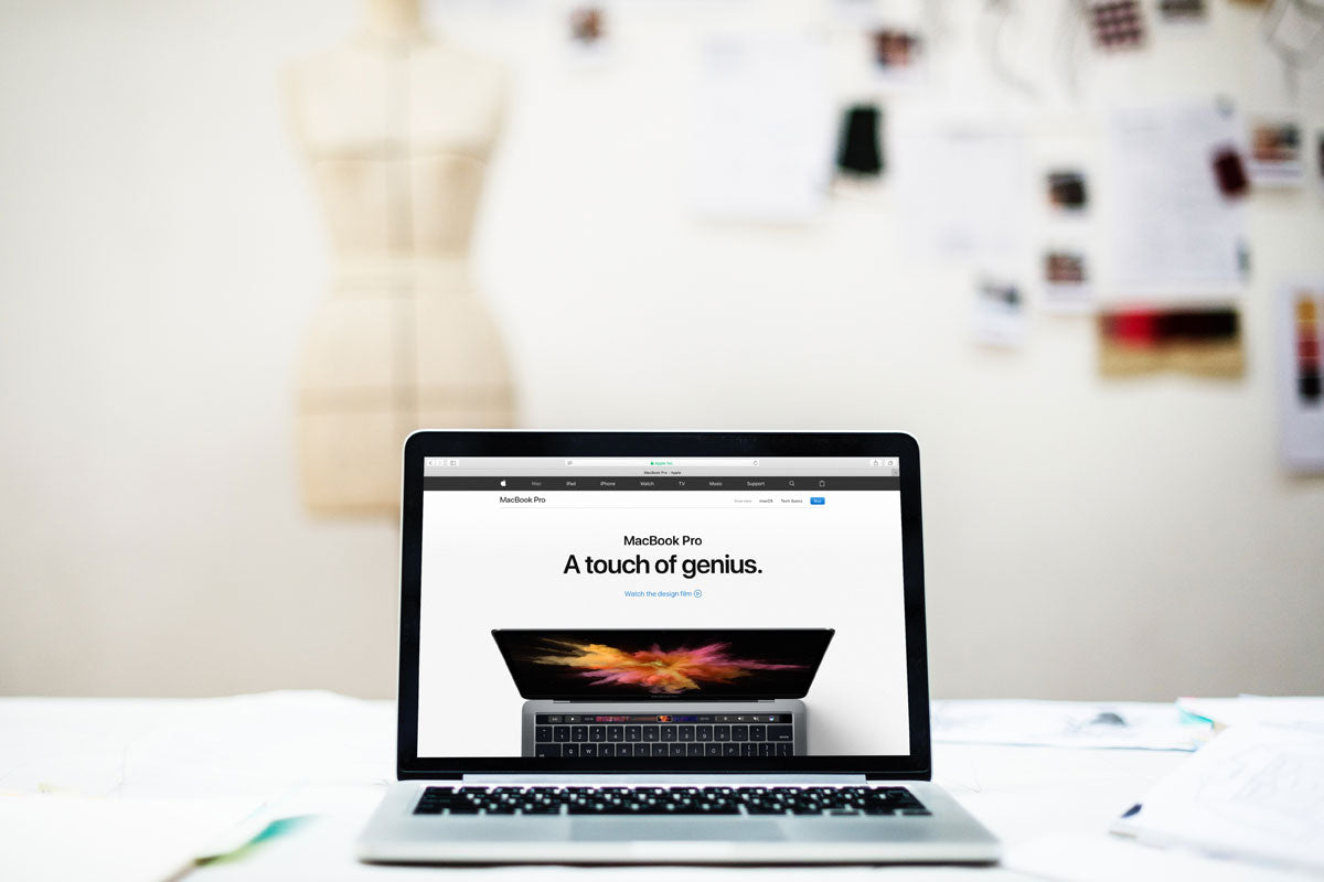 Free Macbook Pro Mockup on Table With Blurred Background