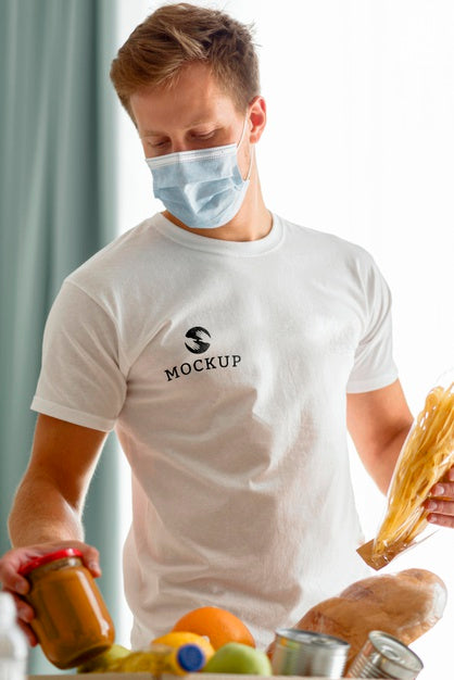 Free Male Volunteer With Medical Mask Preparing Food Donation Box Psd