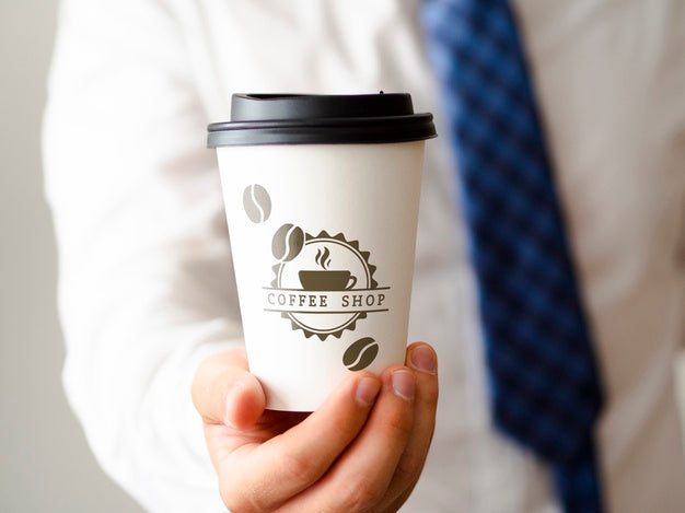 Free Man Holding A Cup Of Coffee Mock-Up Psd