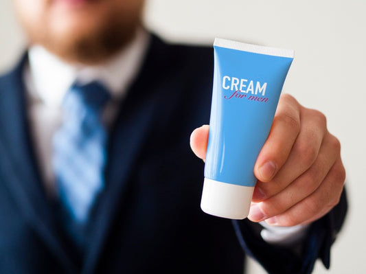 Free Man Holding A Hand Cream Bottle For Man Mock-Up Psd