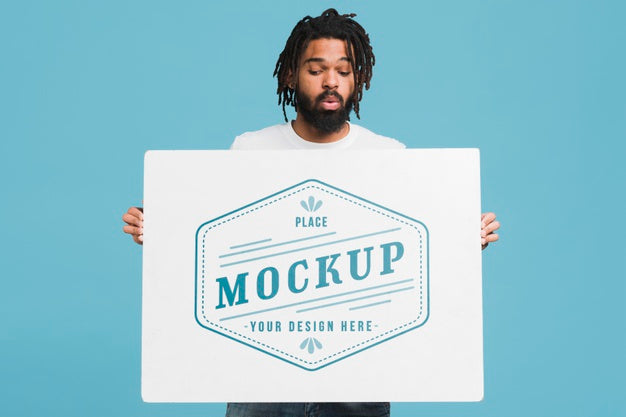 Free Man Holding Poster Mockup Psd