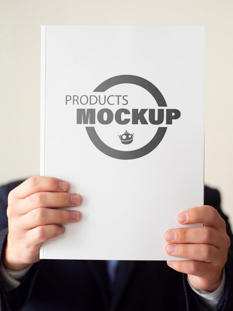 Free Man Holding Up A Notebook Mock-Up Psd