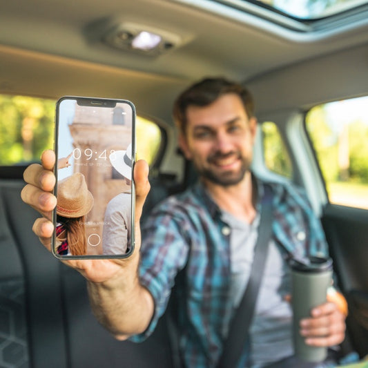 Free Man In Car Showing Smartphone Mockup Psd