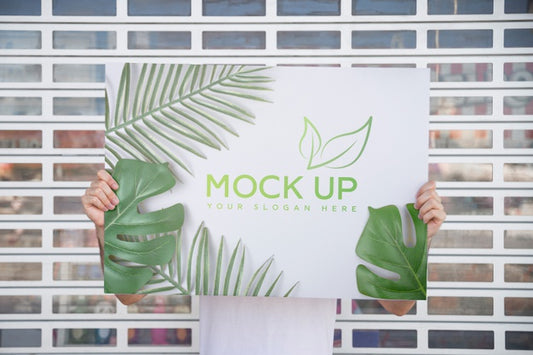 Free Man Presenting Poster Mockup In Front Of Gate Psd