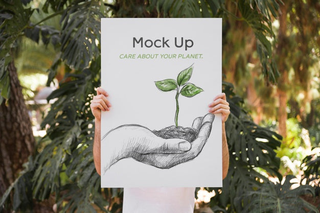 Free Man Presenting Poster Mockup In Front Of Park Psd