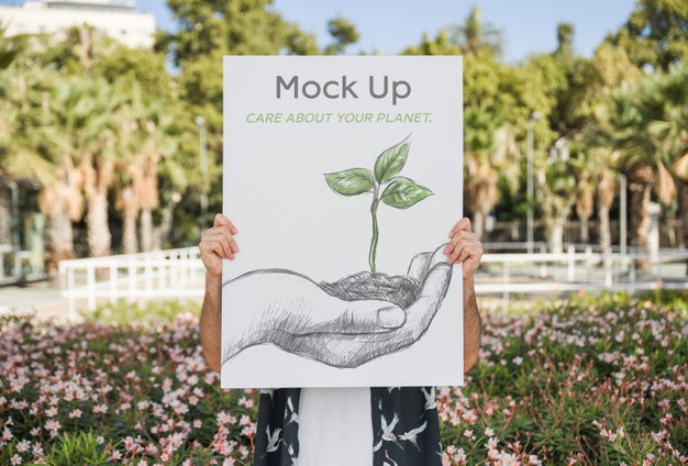 Free Man Presenting Poster Mockup In Front Of Park Psd